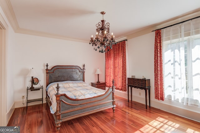 bedroom featuring wood-type flooring, crown molding, and a chandelier