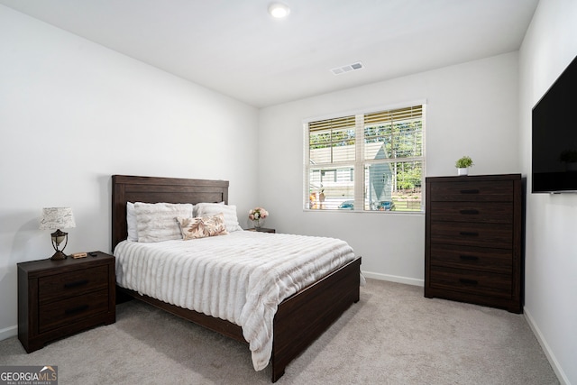 bedroom with light colored carpet