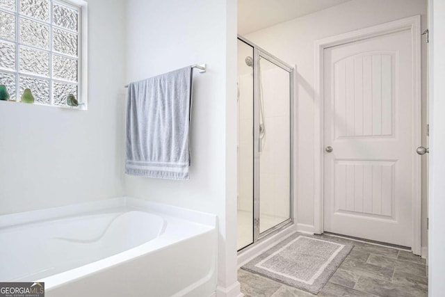 bathroom featuring separate shower and tub