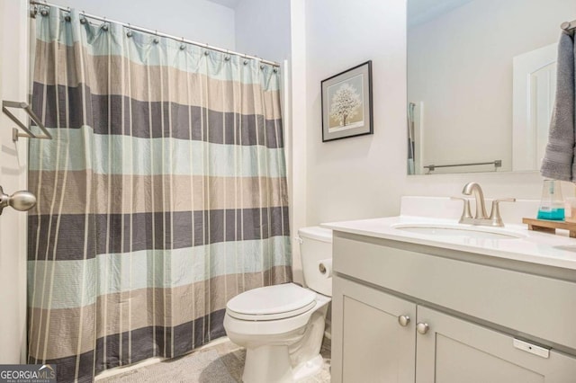 bathroom featuring a shower with shower curtain, vanity, and toilet