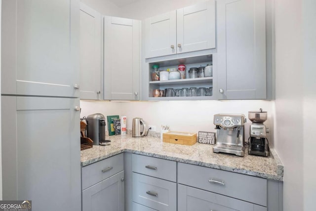 kitchen with gray cabinets and light stone countertops