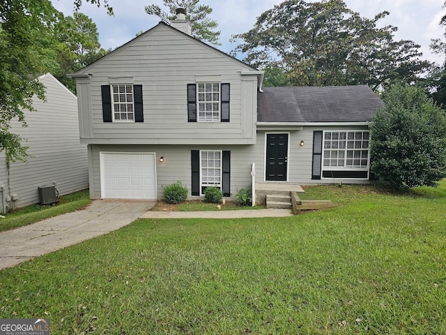 tri-level home featuring a front yard and a garage