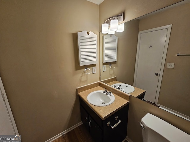 bathroom featuring radiator heating unit, hardwood / wood-style flooring, vanity, and toilet