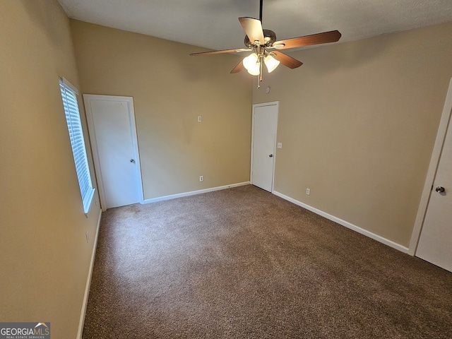 carpeted spare room featuring ceiling fan