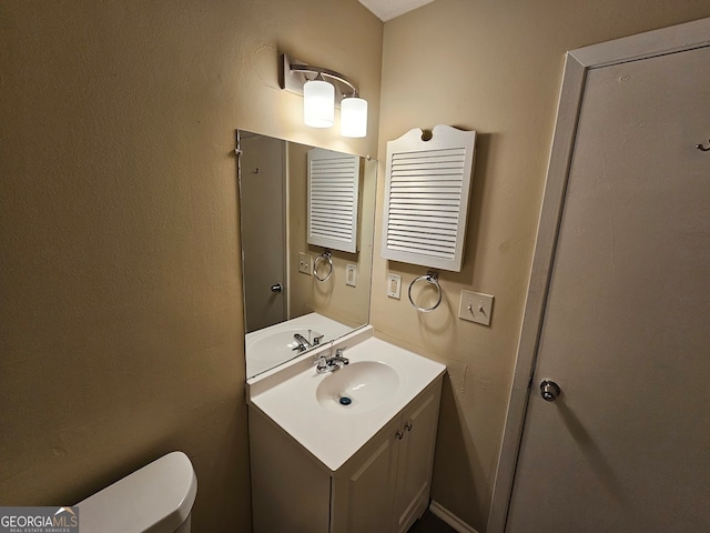 bathroom featuring radiator, vanity, and toilet