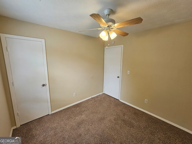 carpeted empty room featuring a textured ceiling and ceiling fan