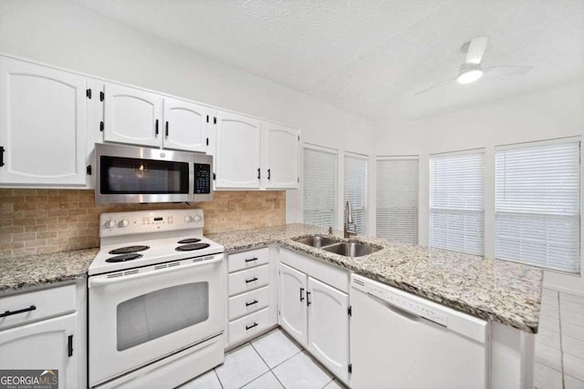 kitchen featuring ceiling fan, white cabinets, kitchen peninsula, and white appliances