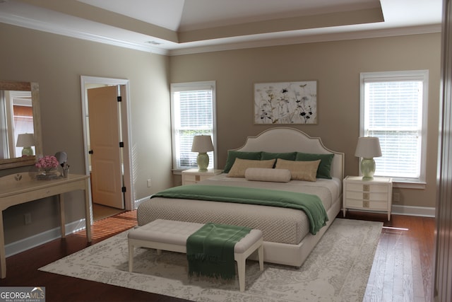 bedroom with multiple windows, crown molding, and hardwood / wood-style flooring