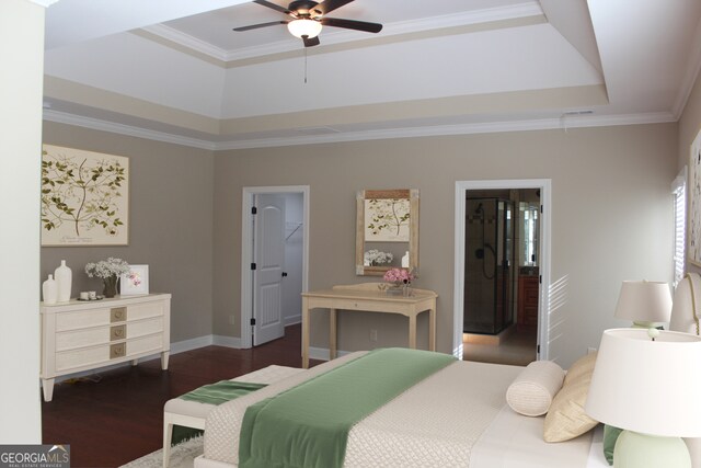 bedroom featuring dark wood-type flooring, a raised ceiling, ceiling fan, a spacious closet, and ornamental molding