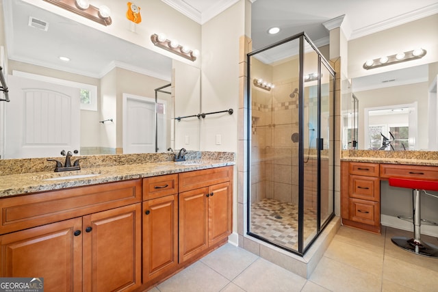 bathroom with tile patterned flooring, vanity, an enclosed shower, and ornamental molding