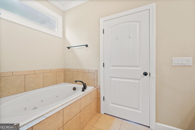 bathroom with tile patterned floors, crown molding, and tiled tub