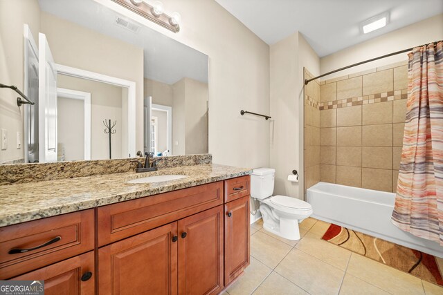 full bathroom with tile patterned flooring, shower / bath combination with curtain, toilet, and vanity