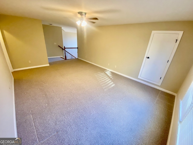 carpeted spare room with ceiling fan