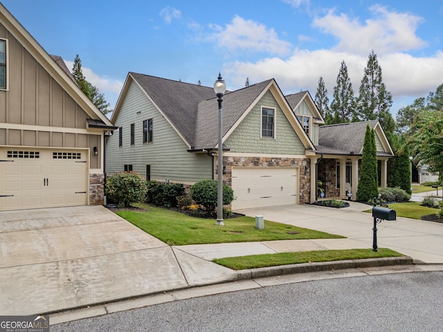 craftsman inspired home featuring a front yard and a garage