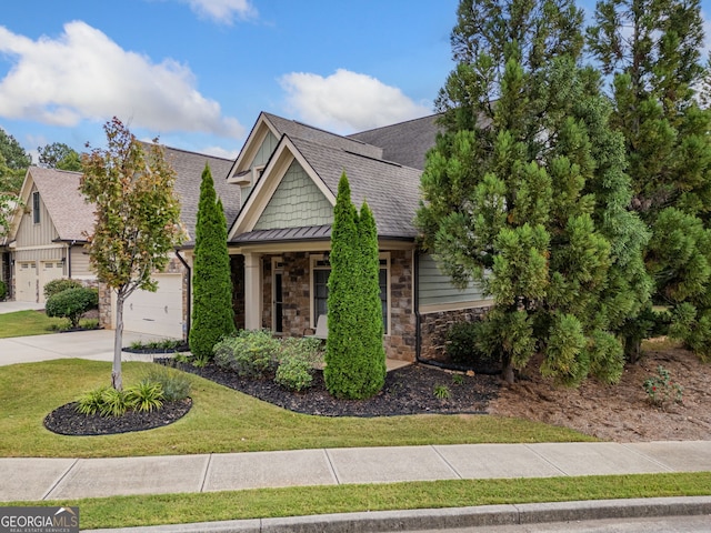 view of front of property featuring a garage and a front lawn