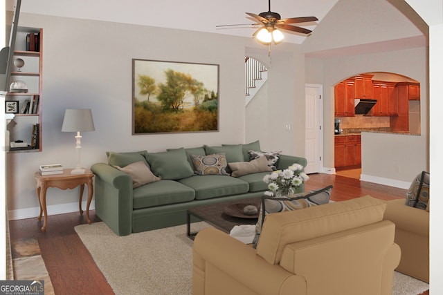 living room featuring ceiling fan and dark wood-type flooring