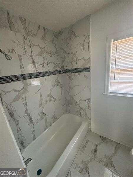 bathroom featuring separate shower and tub