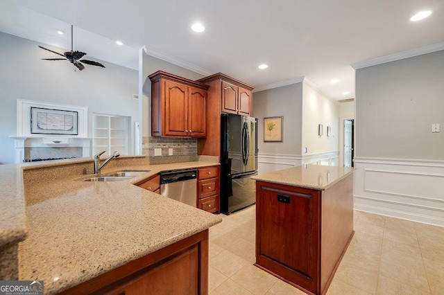 kitchen featuring stainless steel dishwasher, black fridge, light stone countertops, and sink