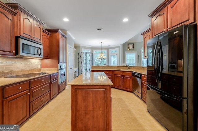 kitchen featuring kitchen peninsula, black appliances, pendant lighting, a chandelier, and a kitchen island