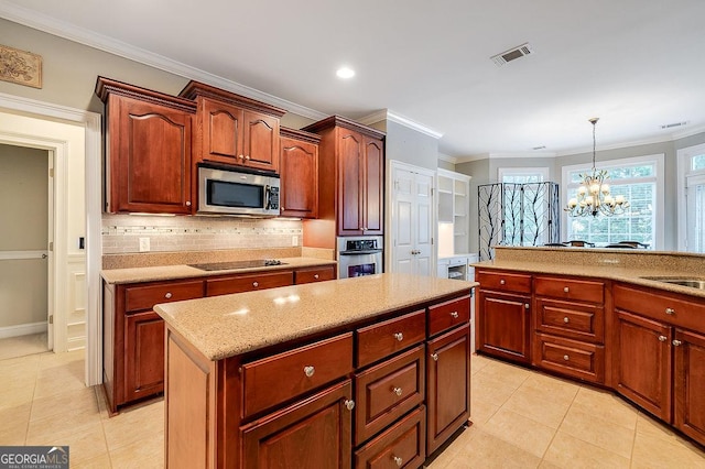 kitchen with pendant lighting, backsplash, ornamental molding, a notable chandelier, and stainless steel appliances