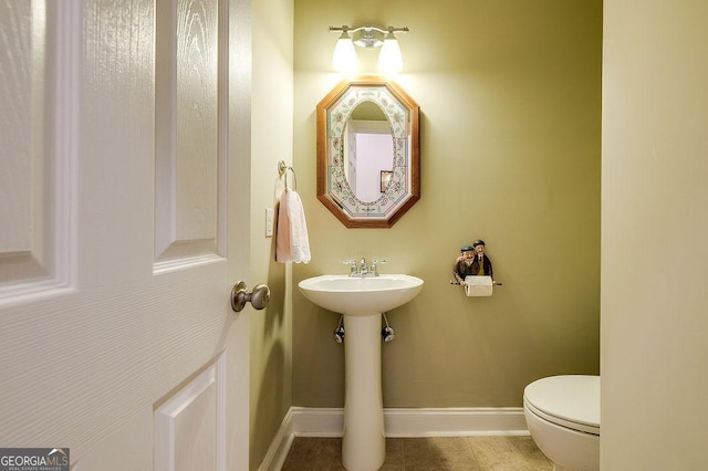 bathroom featuring tile patterned floors and toilet