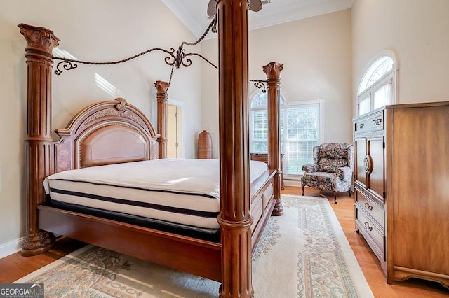 bedroom with light hardwood / wood-style flooring and vaulted ceiling