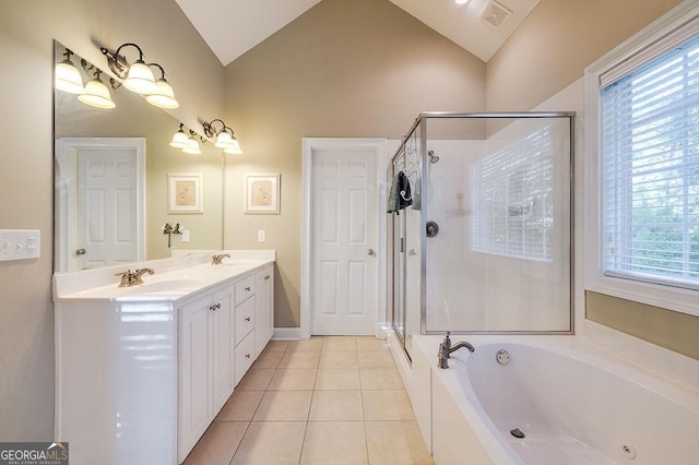 bathroom with a wealth of natural light, tile patterned flooring, independent shower and bath, and vaulted ceiling