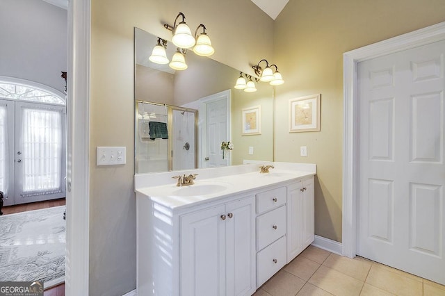 bathroom featuring tile patterned flooring, vanity, a notable chandelier, and a shower with shower curtain