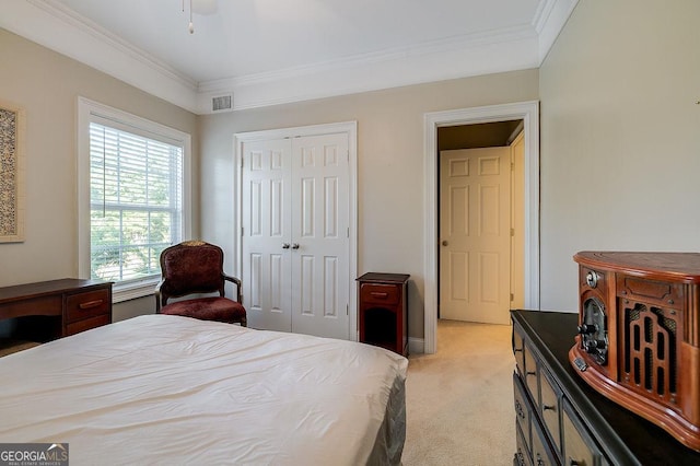 bedroom featuring light carpet, a closet, and ornamental molding