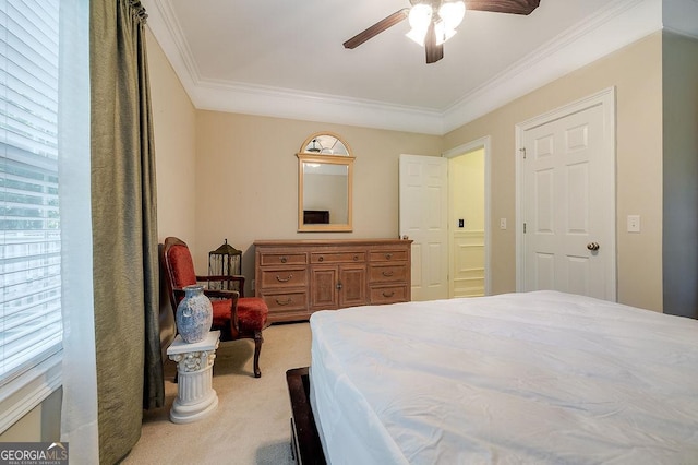 bedroom with ceiling fan, light colored carpet, and crown molding