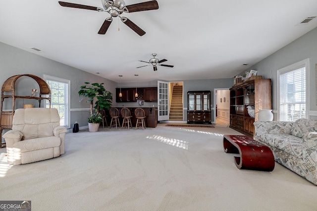 living room featuring ceiling fan and carpet floors