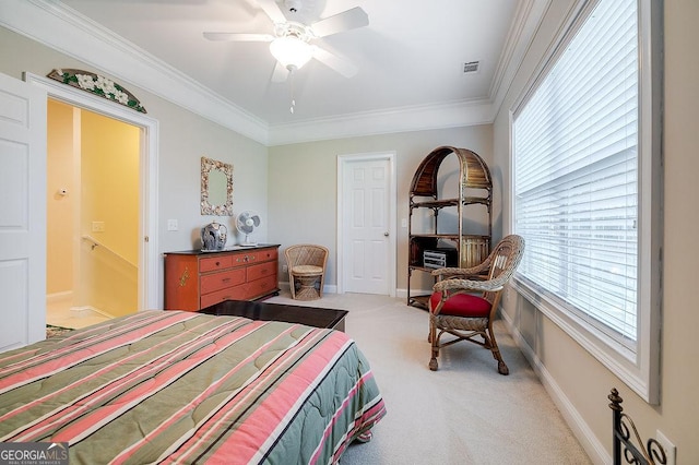 carpeted bedroom with ceiling fan and ornamental molding