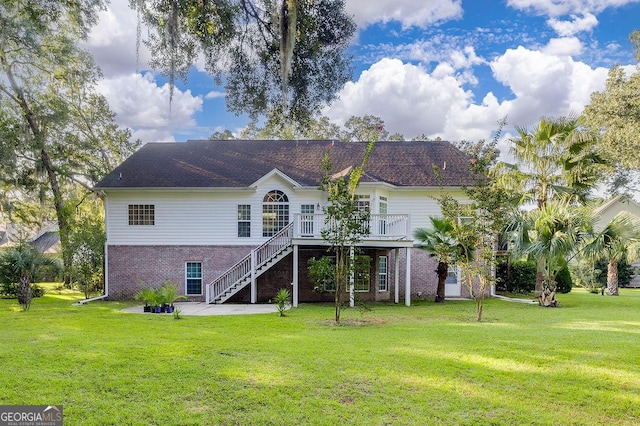 rear view of house featuring a deck and a yard