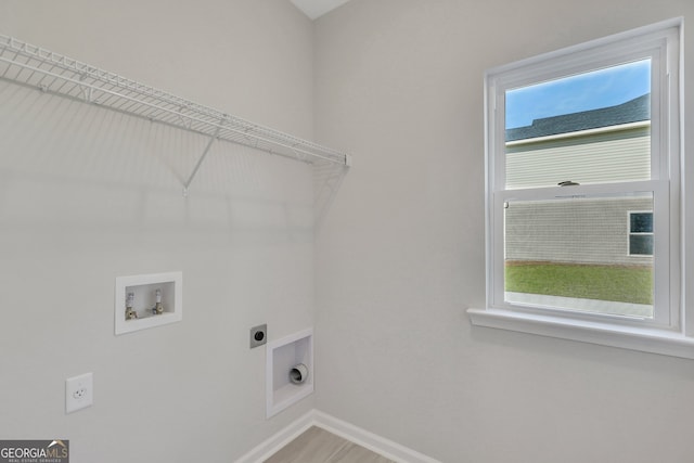 laundry area with hookup for a washing machine, plenty of natural light, and hookup for an electric dryer