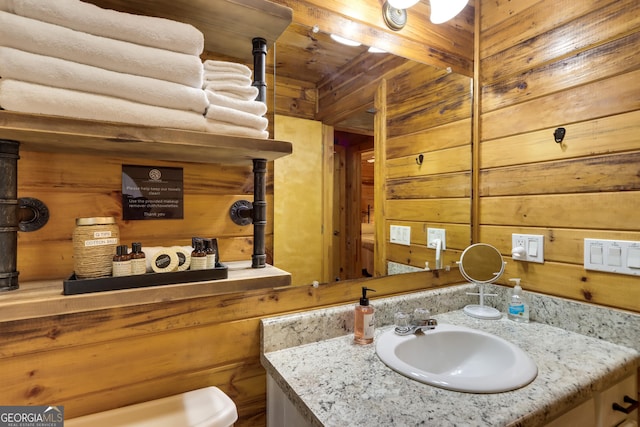 bathroom with wooden walls and vanity