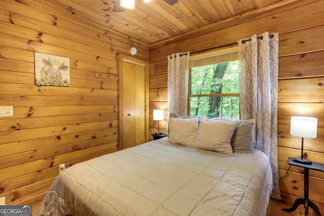 bedroom featuring wooden ceiling and wooden walls