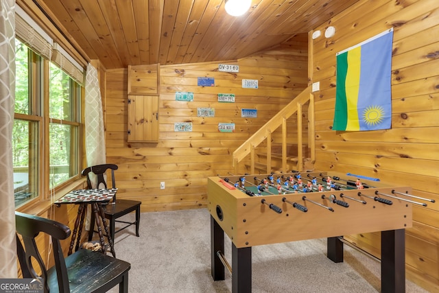 rec room featuring carpet floors, wooden ceiling, and wooden walls