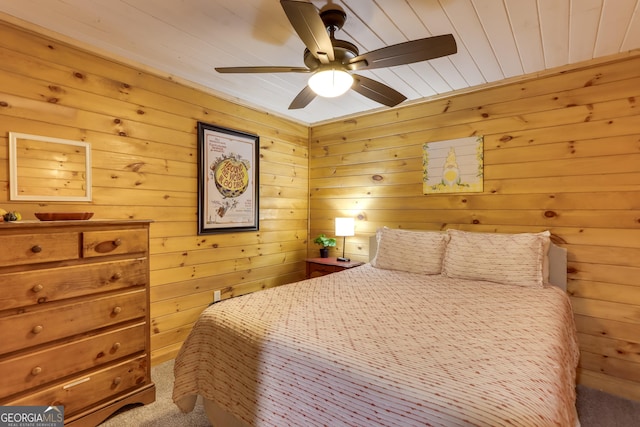 bedroom with wood ceiling, carpet, wooden walls, and ceiling fan