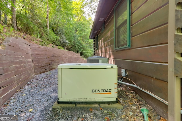 exterior details featuring fence and a power unit