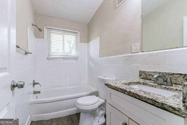 1278 Lynwyn Ln SE, Atlanta, GA 30316 - bathroom featuring vanity, wood finished floors, visible vents, tile walls, and toilet