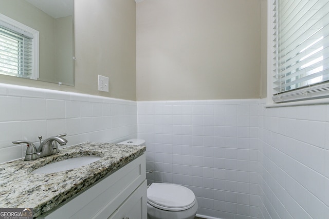 1278 Lynwyn Ln SE, Atlanta, GA 30316 - bathroom with wainscoting, vanity, toilet, and tile walls