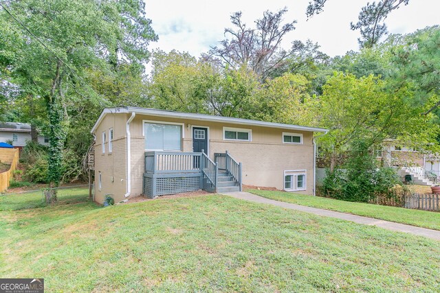 1278 Lynwyn Ln SE, Atlanta, GA 30316 - view of front of home featuring brick siding, a front lawn, and fence