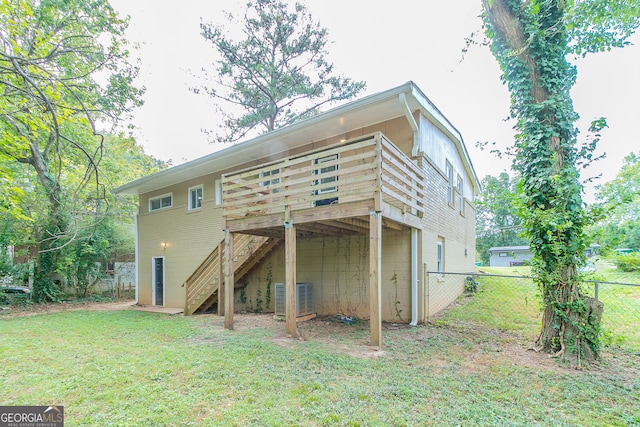 1278 Lynwyn Ln SE, Atlanta, GA 30316 - back of property with central AC unit, fence, a wooden deck, stairs, and a lawn