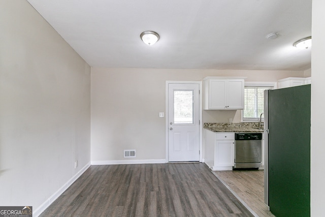 1278 Lynwyn Ln SE, Atlanta, GA 30316 - kitchen featuring baseboards, visible vents, dark wood-type flooring, white cabinets, and appliances with stainless steel finishes