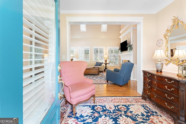 sitting room featuring ornamental molding and hardwood / wood-style floors