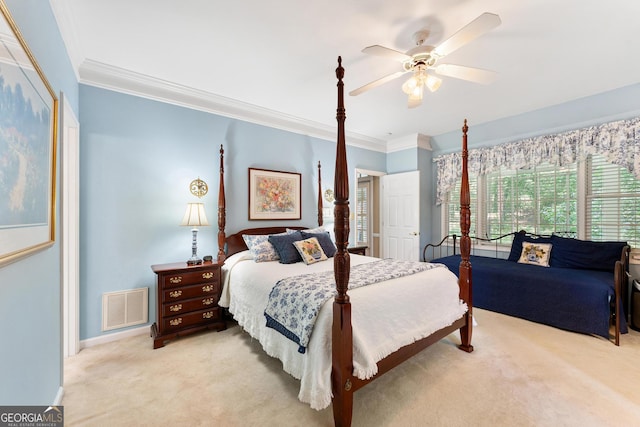 carpeted bedroom with crown molding and ceiling fan