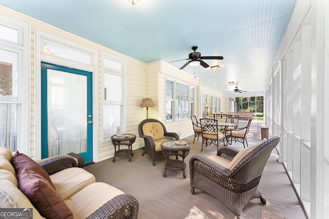 sunroom featuring ceiling fan