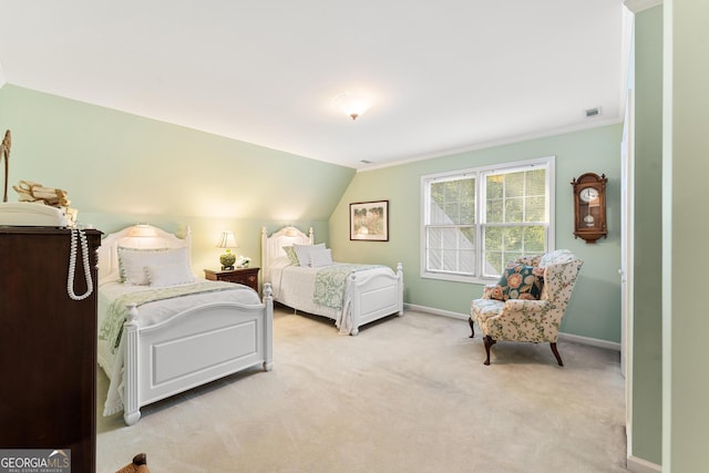 bedroom with crown molding, lofted ceiling, and light colored carpet