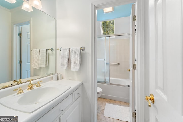 full bathroom featuring tile patterned floors, bath / shower combo with glass door, vanity, and toilet