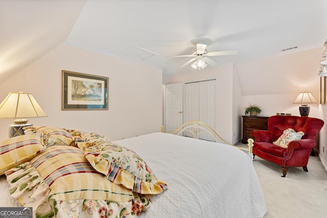 bedroom featuring ceiling fan, light colored carpet, a closet, and lofted ceiling